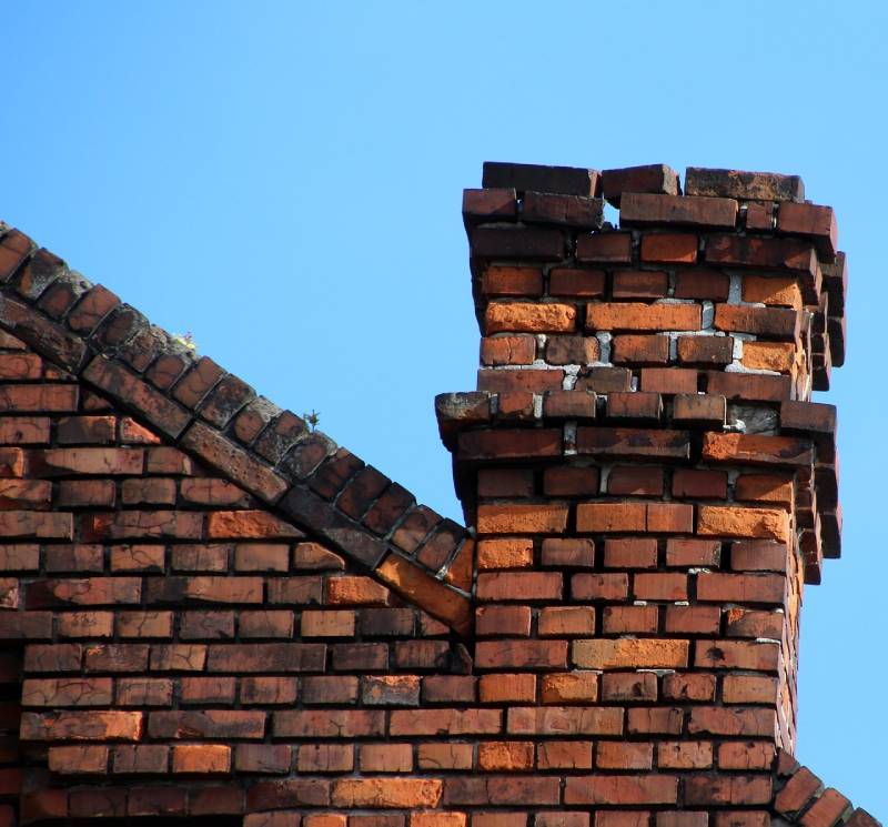 Signs Your Belmont Home Needs a Chimney Inspection Damaged chimney on an Belmont home showing cracks and missing mortar